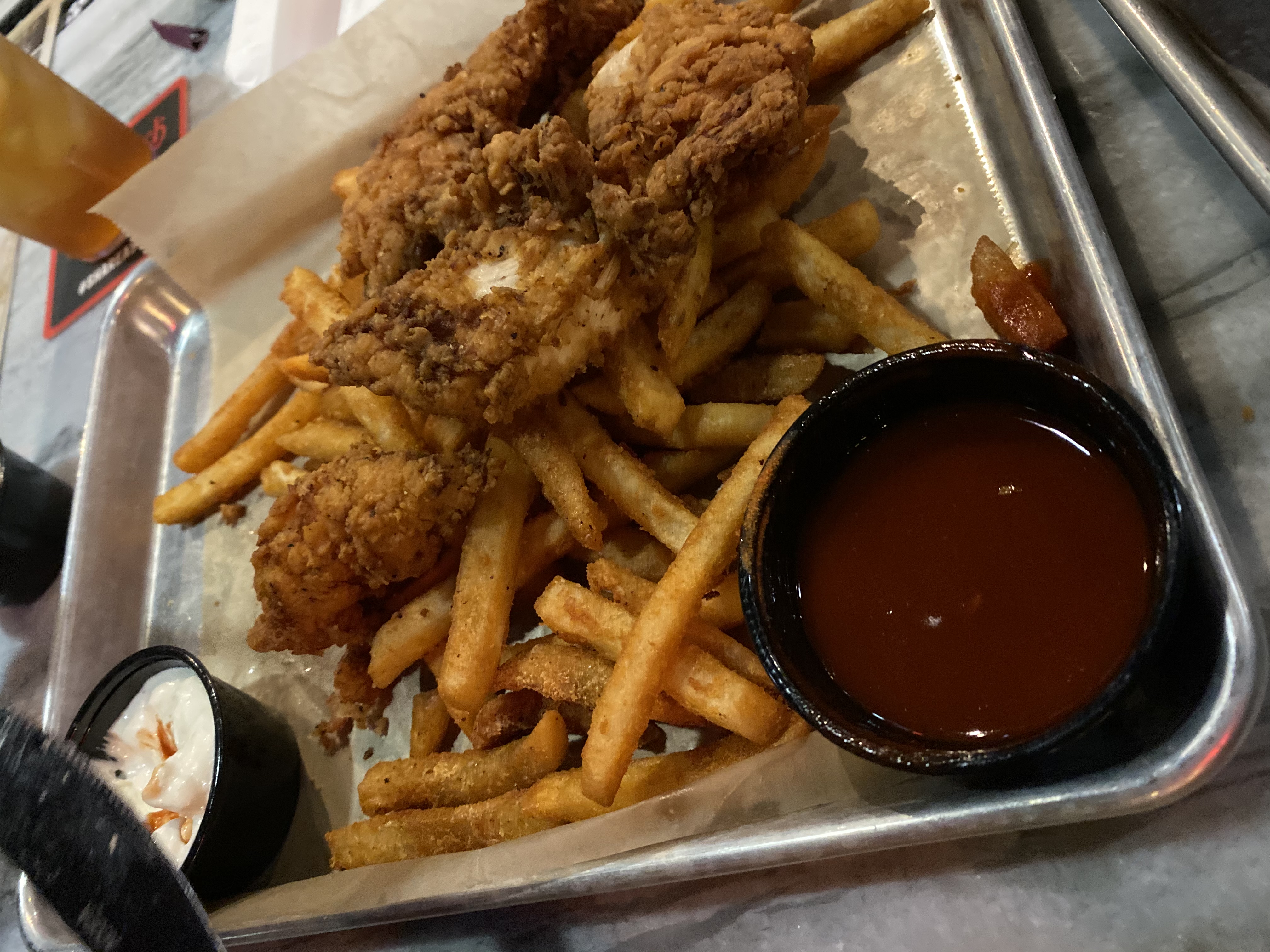 Chicken tenders and seasoned fries with dipping sauces at Jack's Public House in Braselton Georgia