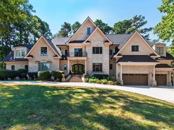 Executive estate home in Cary, NC with stone facade and manicured landscaping