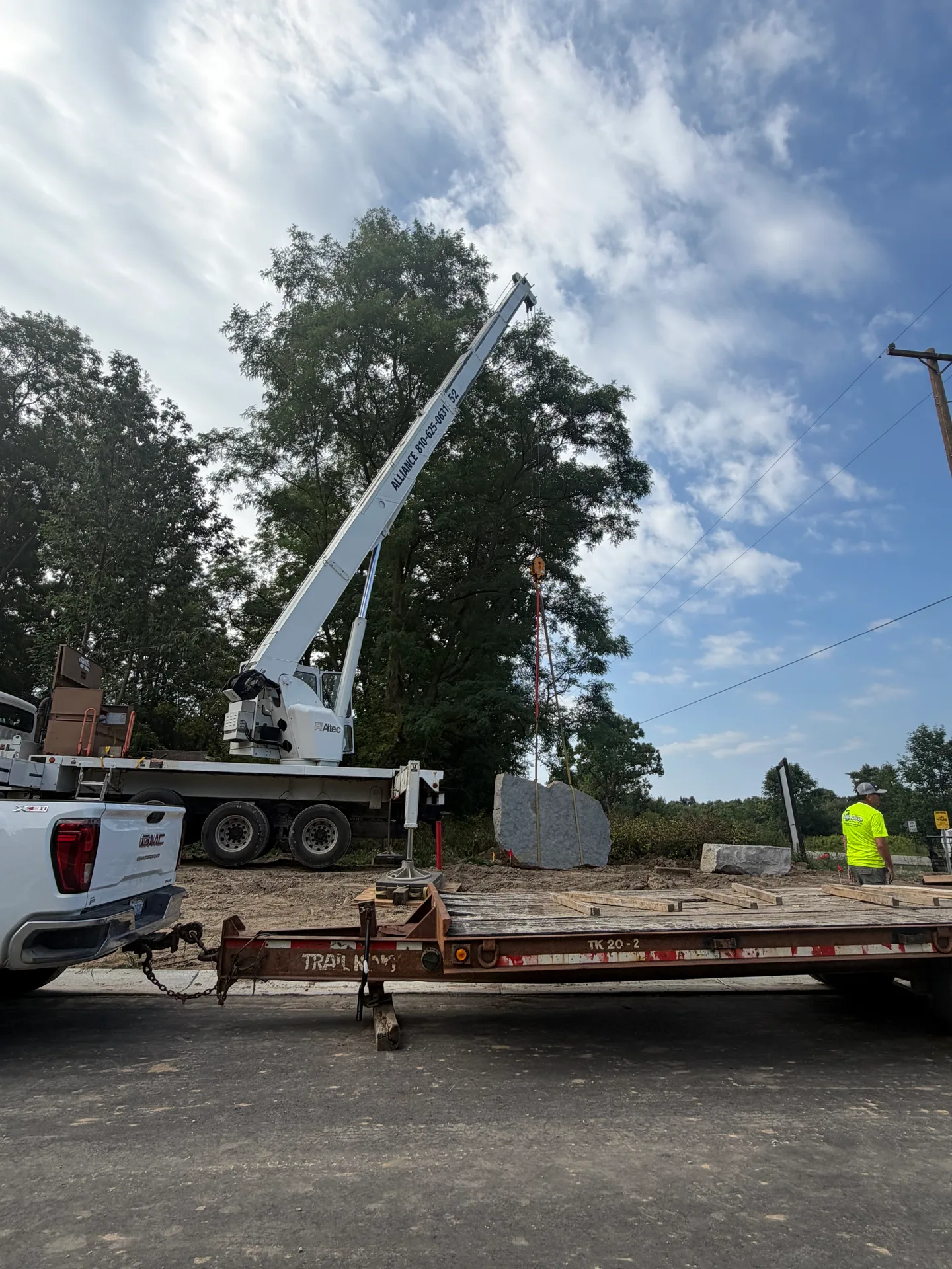Side view of the heavy equipment used to place the 14,000-pound entrance stone at Oaks of Tyrone new construction community in Tyrone Township Michigan