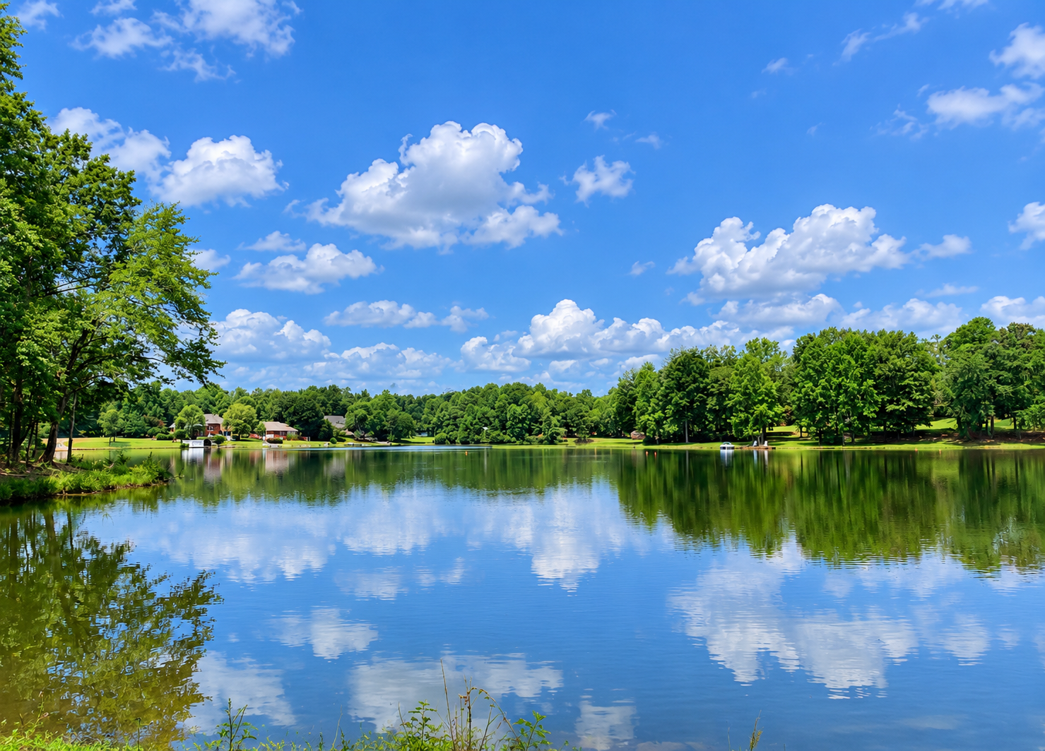 Tranquil lake with cloud reflections in Foxchase on Emerald Lake, Opelika, Alabama