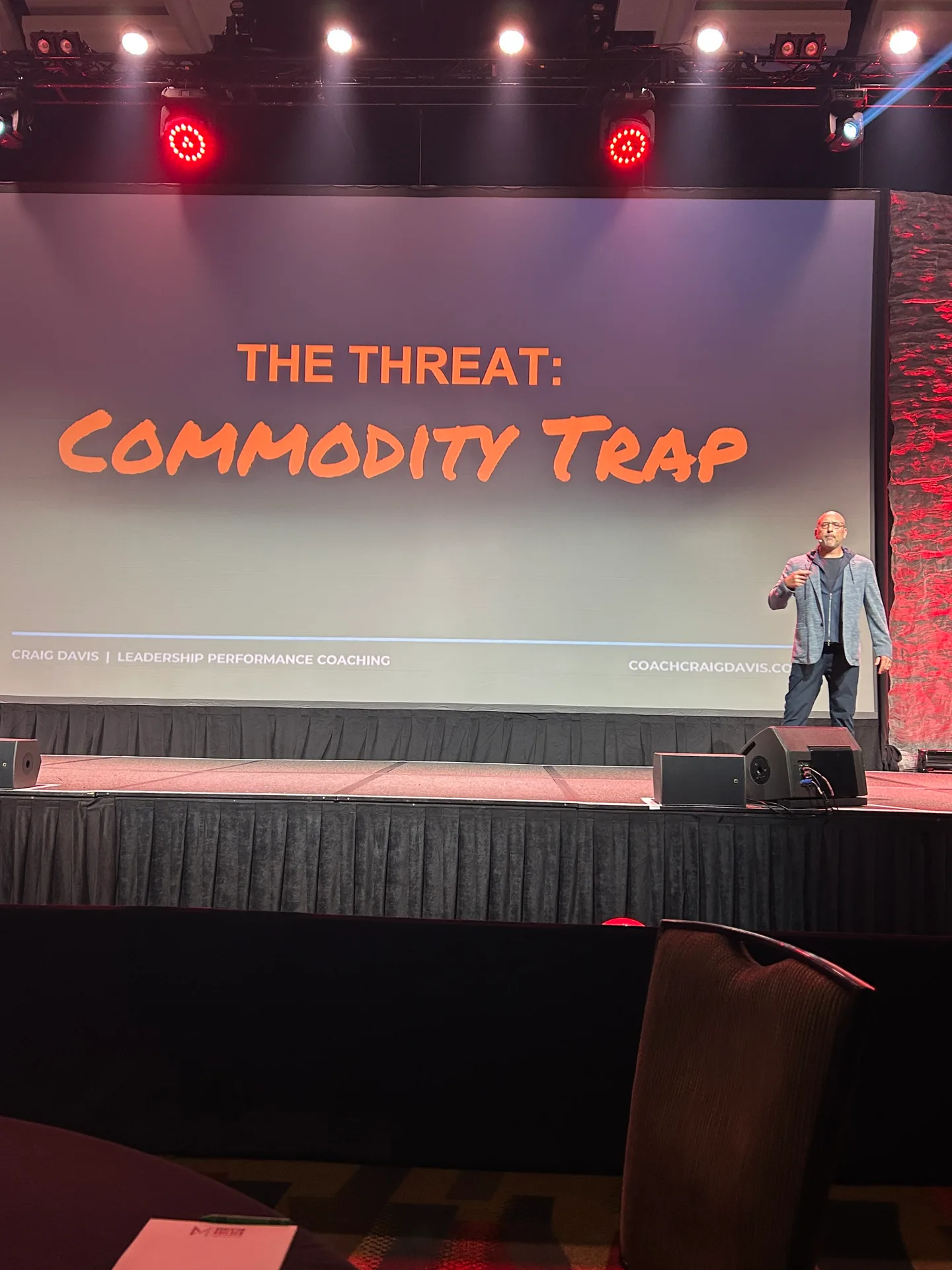 Craig Davis on stage presenting The Threat: Commodity Trap during his keynote at Momentum Builder Live