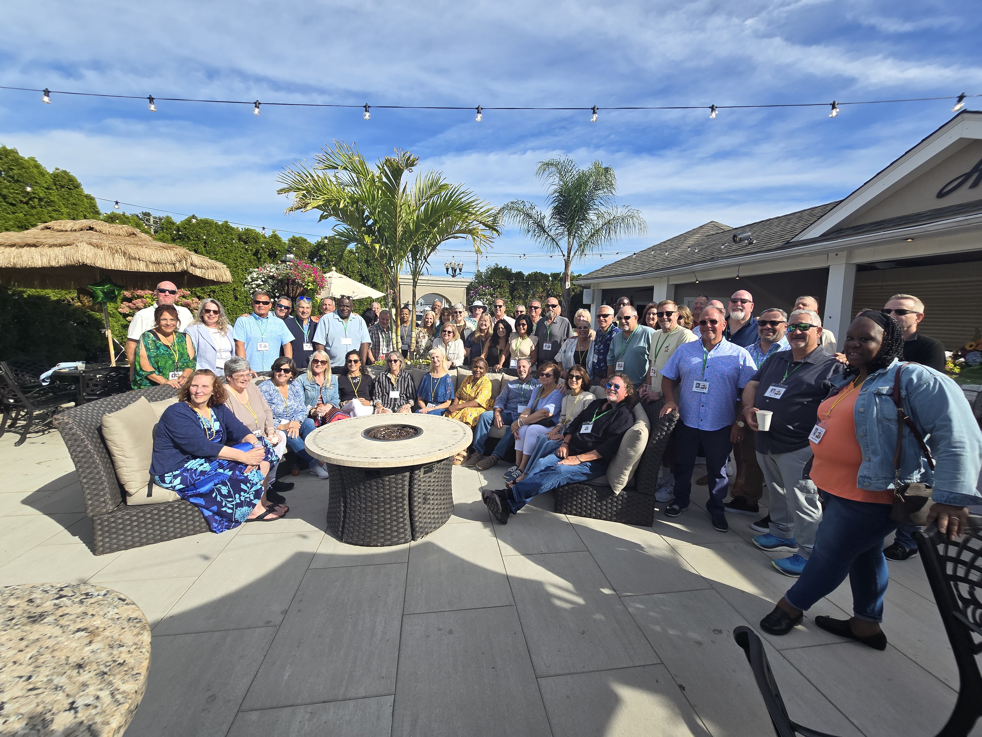 The full crowd of more than 40 Hamden High Class of 1981 classmates wearing name tags gathered around the fire pit on the patio at the 45th reunion clam bake.