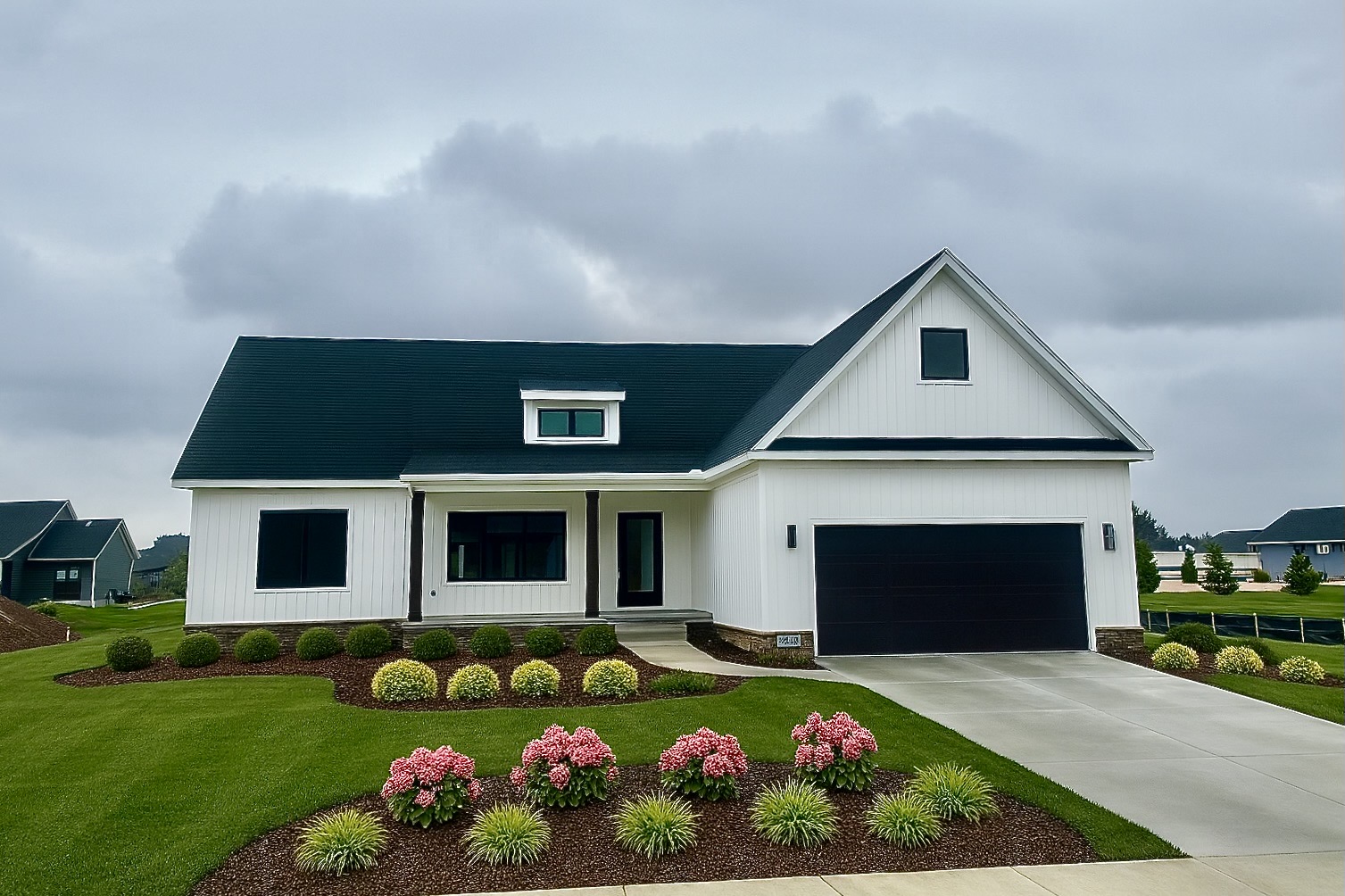 White Modern Farmhouse by Big Sky Development with dark roof and garage, pink hydrangea landscaping