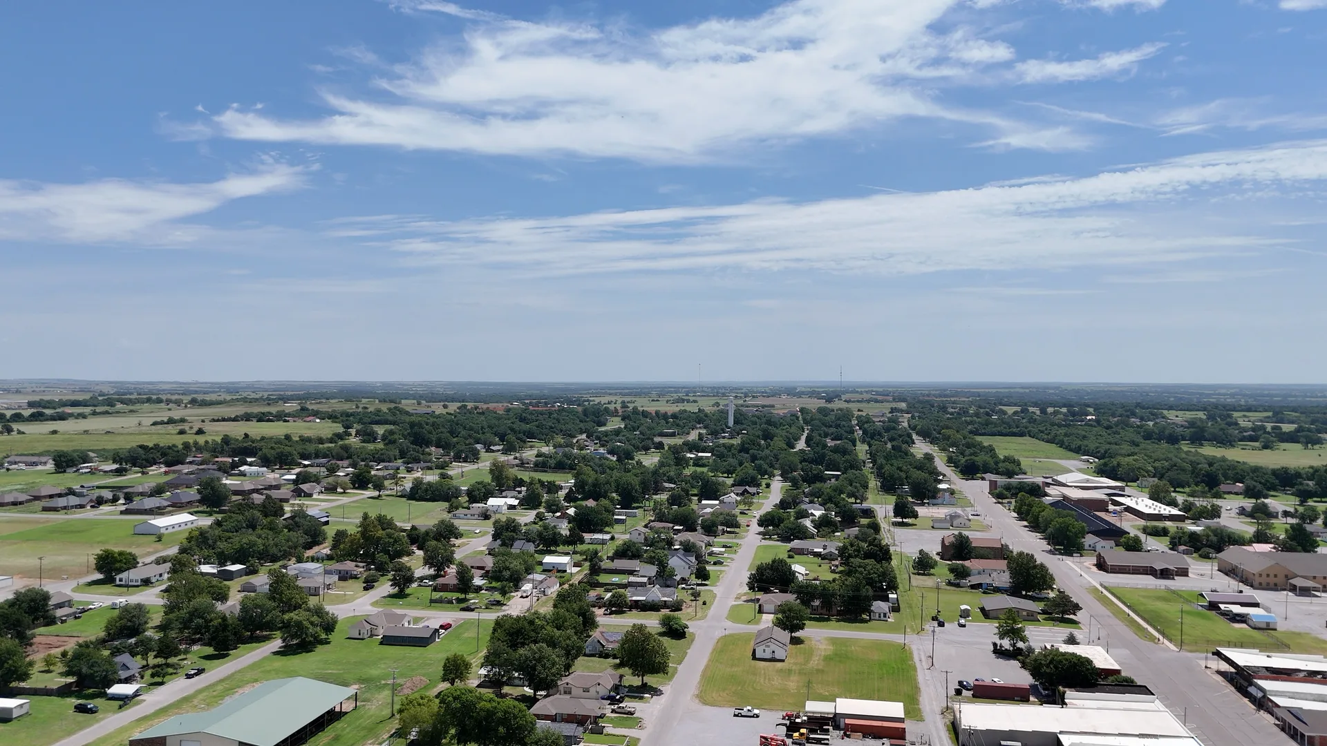 Aerial view of Fletcher, Oklahoma showing a residential area, green space, and a downtown commercial section