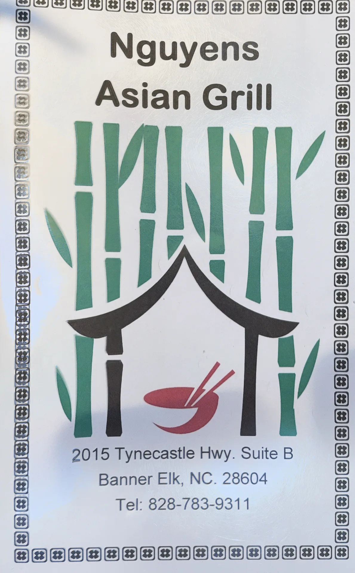 The sign for Nguyen's Asian Grill in Banner Elk, listing the restaurant name with its address and phone number