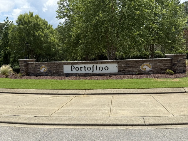 The stone Portofino entrance sign at the gated community