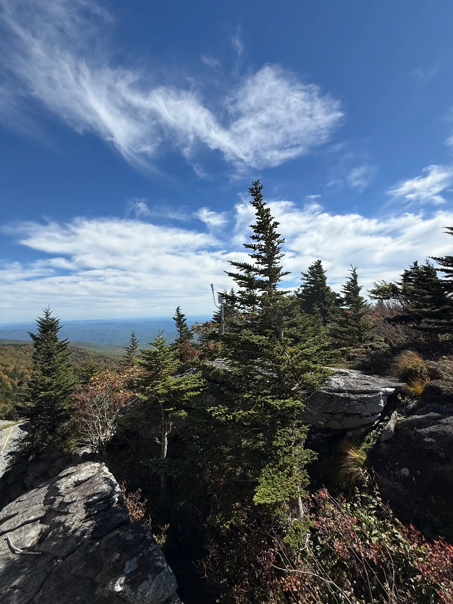 A high-elevation rocky ridge on Grandfather Mountain with boulders and distant mountain layers