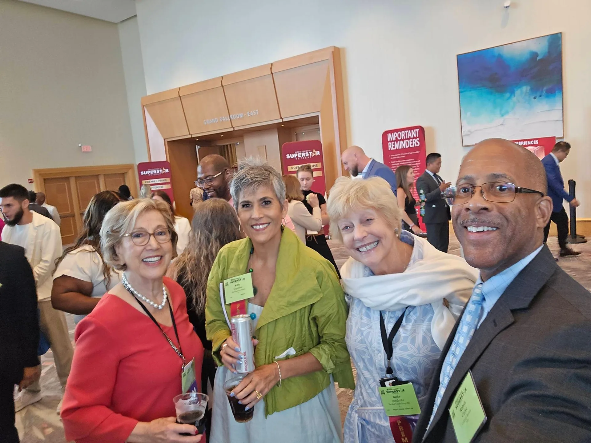 A group selfie of four smiling attendees wearing conference name badges at the Mike Ferry 2026 Superstar Retreat at The Diplomat Beach Resort in Hollywood, Florida, with SUPERSTAR banners and conference room signs visible in the background