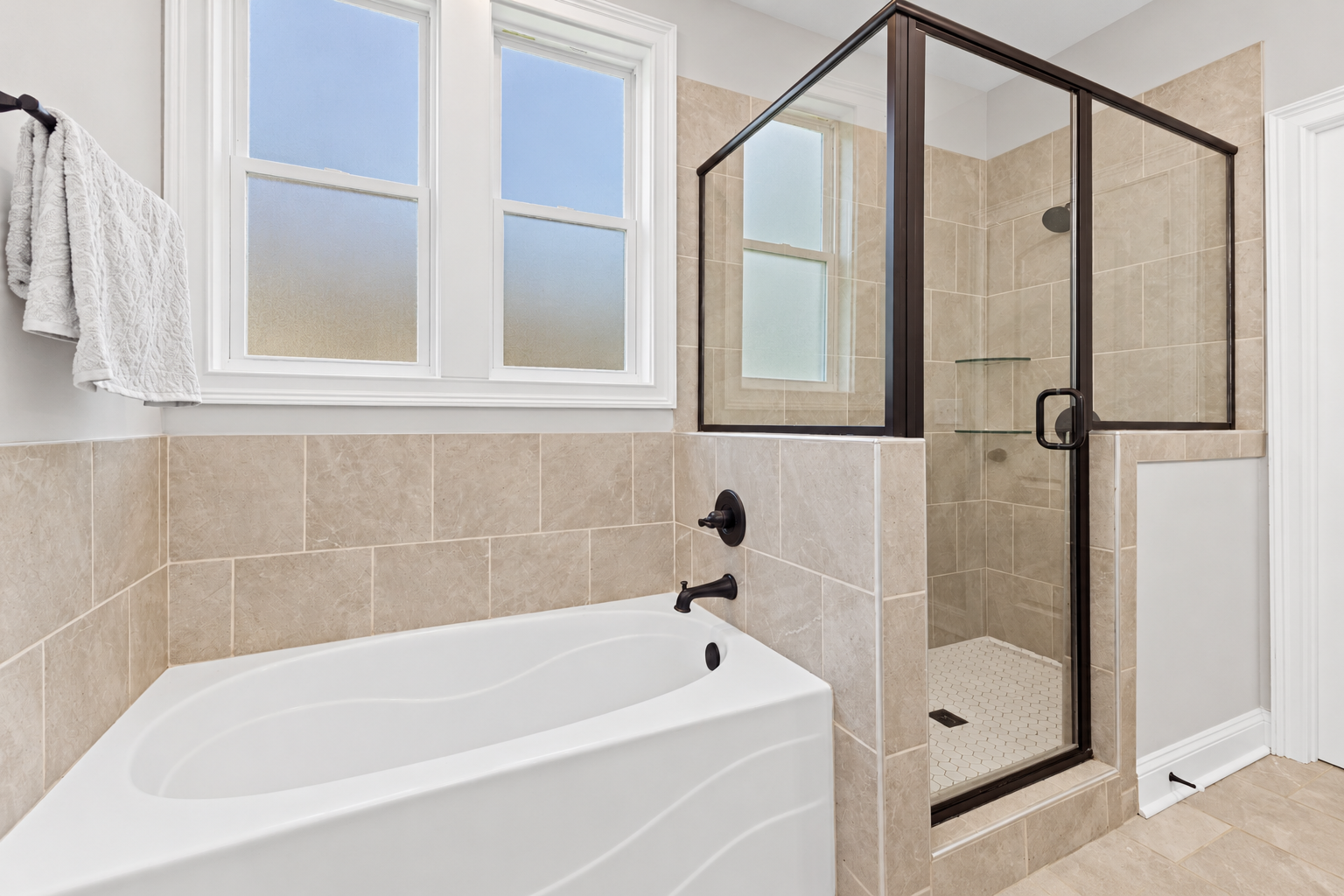Bright contemporary beige-tiled bathroom at 1537 Dartmouth Dr, Auburn AL