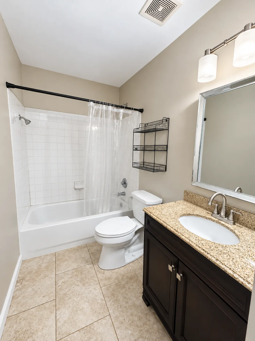 Bathroom with a tub and shower and a wood vanity in the Summerwood short sale in Stafford VA