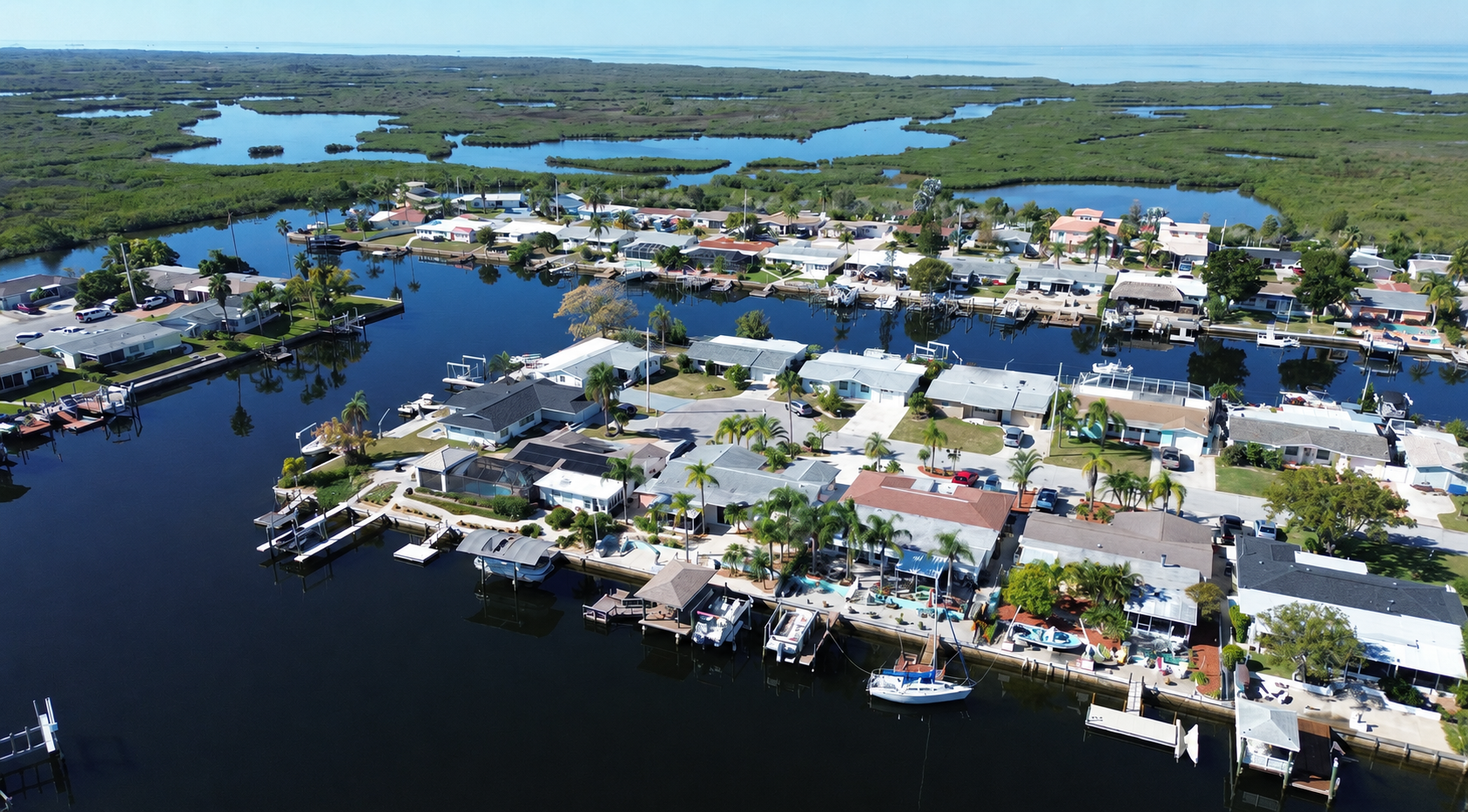 Aerial view of a waterfront canal community in Hudson, FL