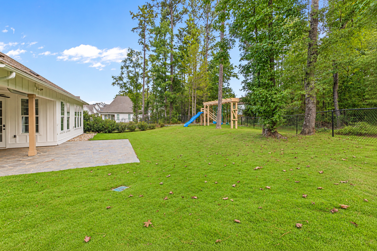 Bright suburban backyard with plants at 1537 Dartmouth Dr, Auburn AL