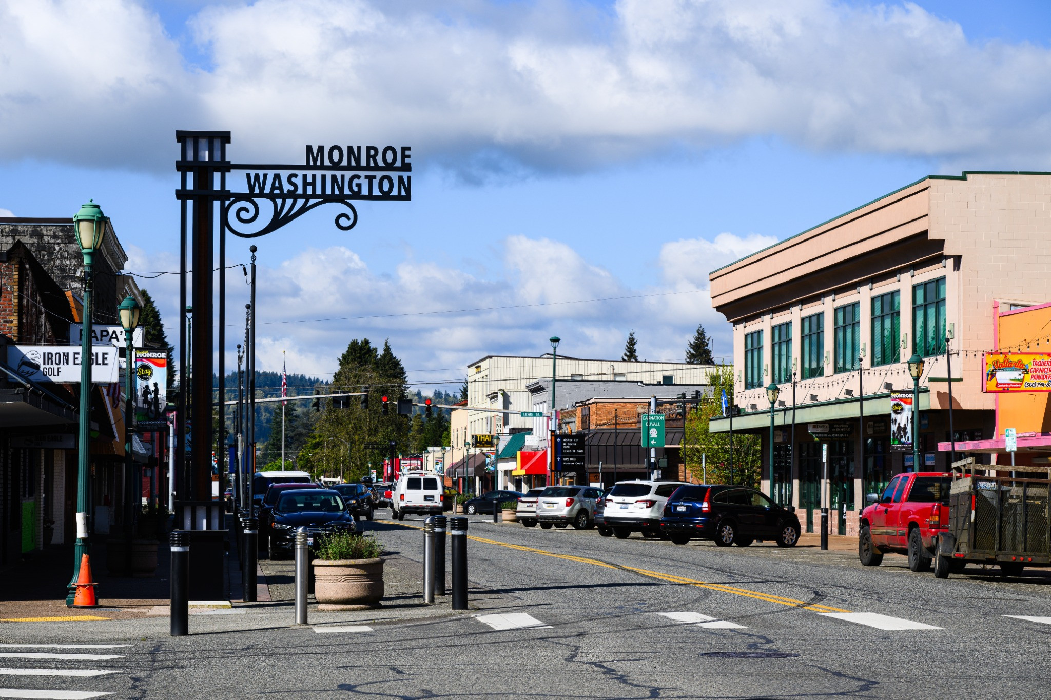 Historic downtown Monroe, Washington, seen along the commercial Main Street with the city sign overhead
