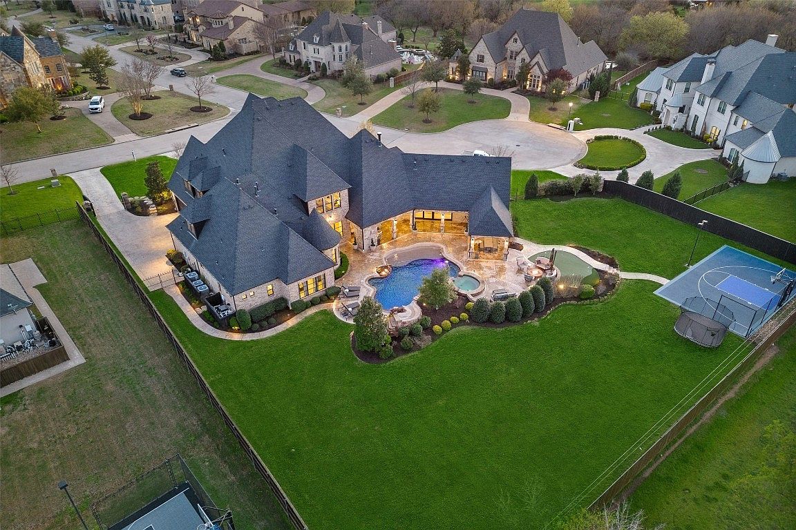 Brick-and-stone homes on a tree-lined street in Southlake, Texas.