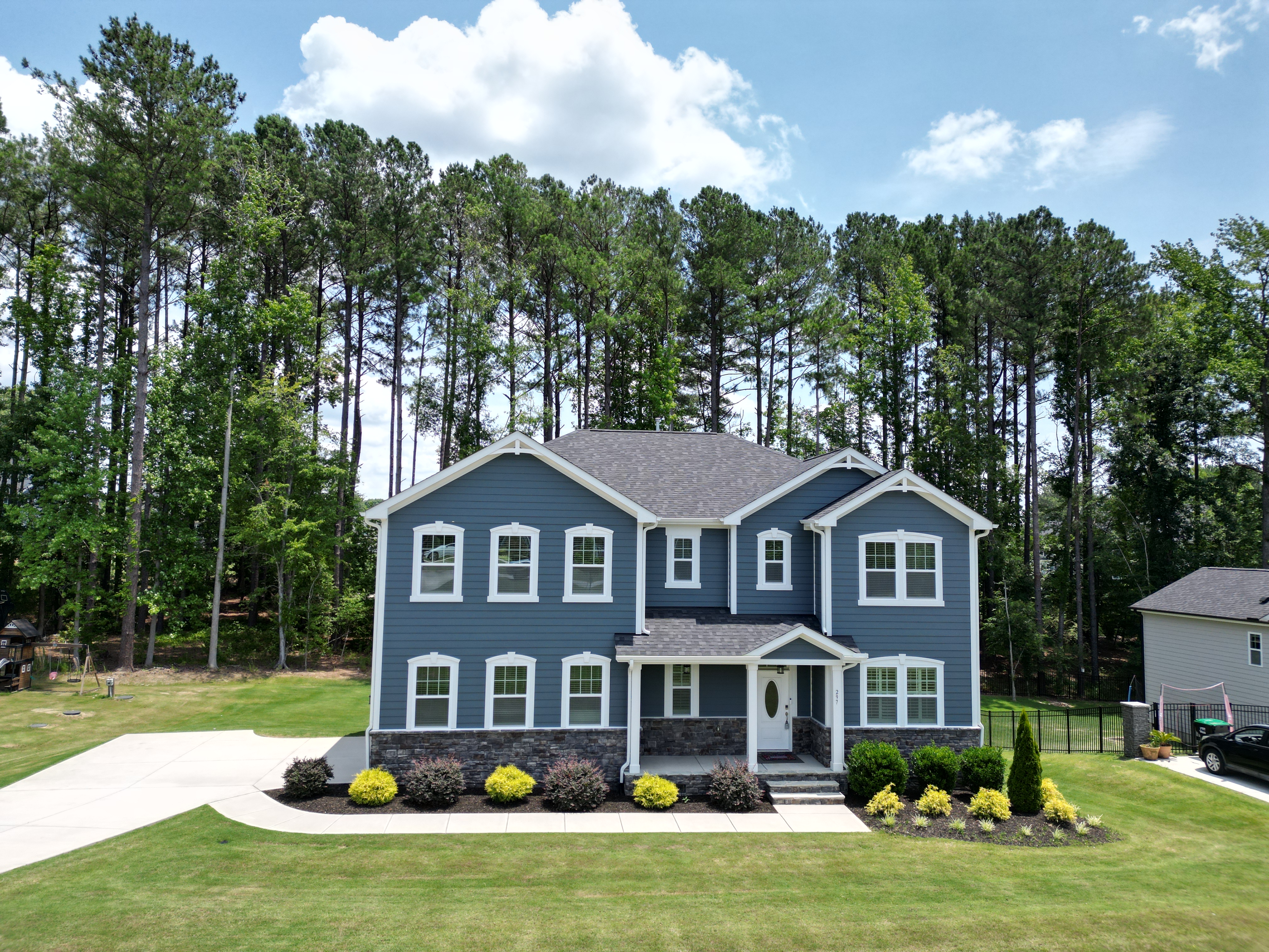 Aerial drone photo of 297 Bonaventure Drive showing the property's roof, lot, and surrounding neighborhood