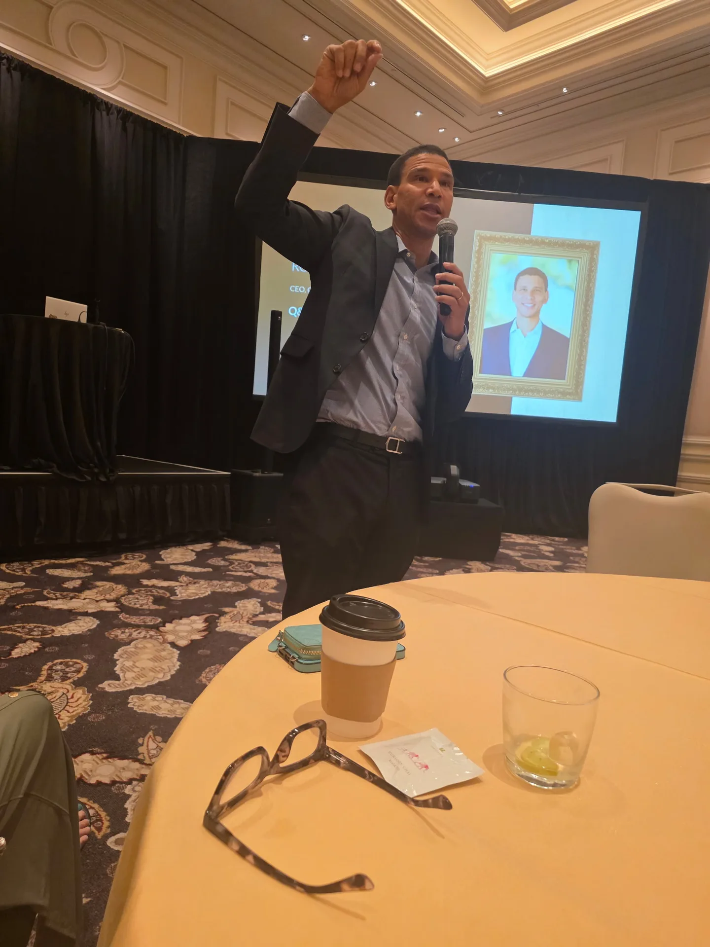 A speaker addresses the audience from the podium at the Better Homes and Gardens Real Estate retreat