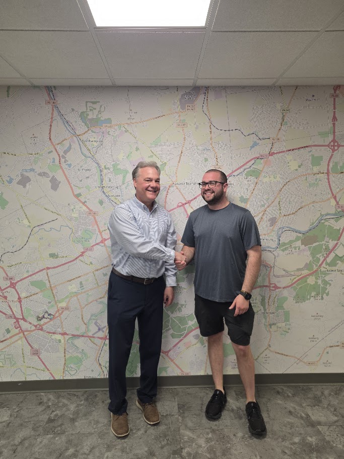 Tim Tepes with a client reviewing documents