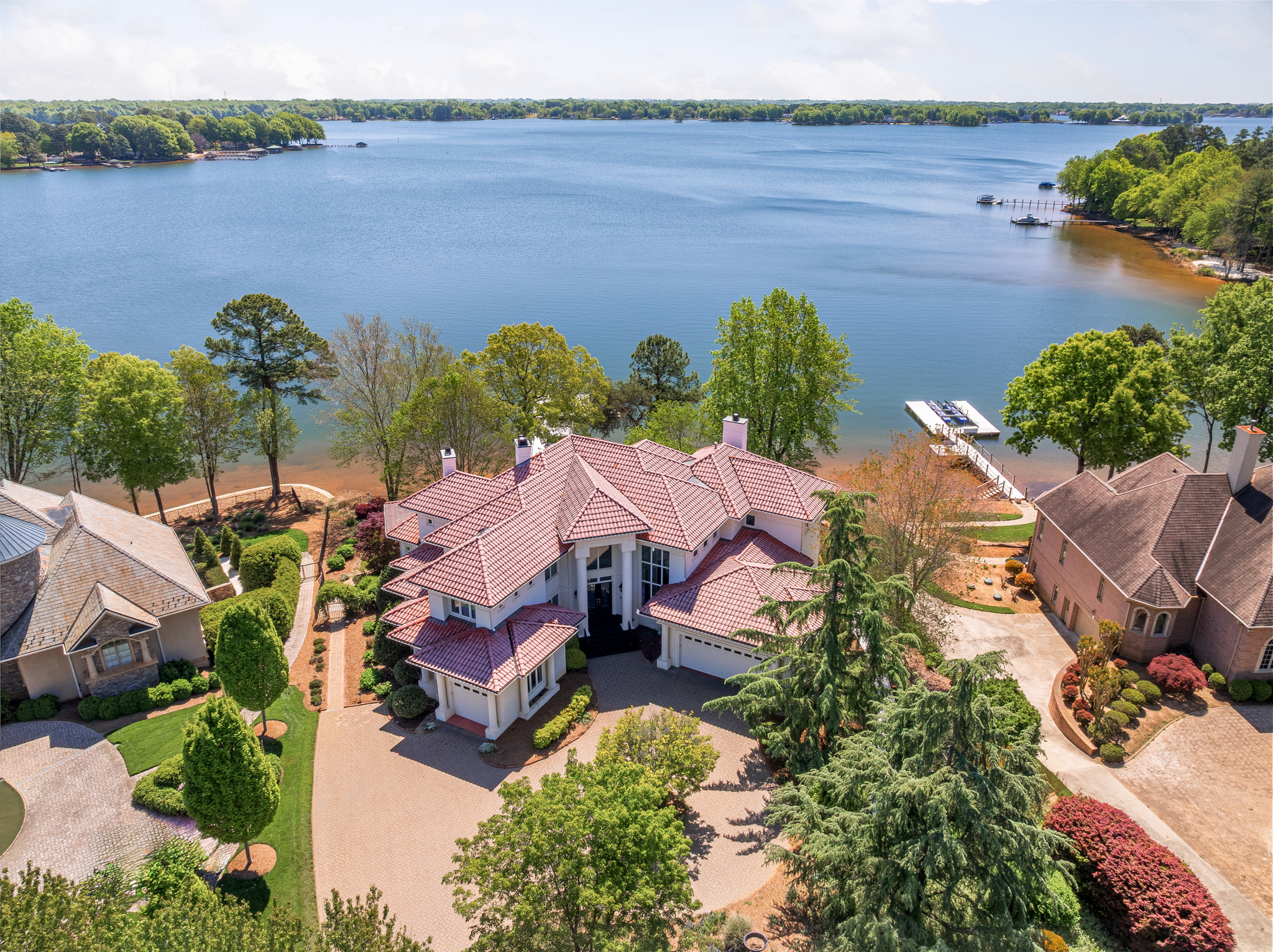 Panoramic sunset view of Lake Norman waterfront homes and docks along the shoreline