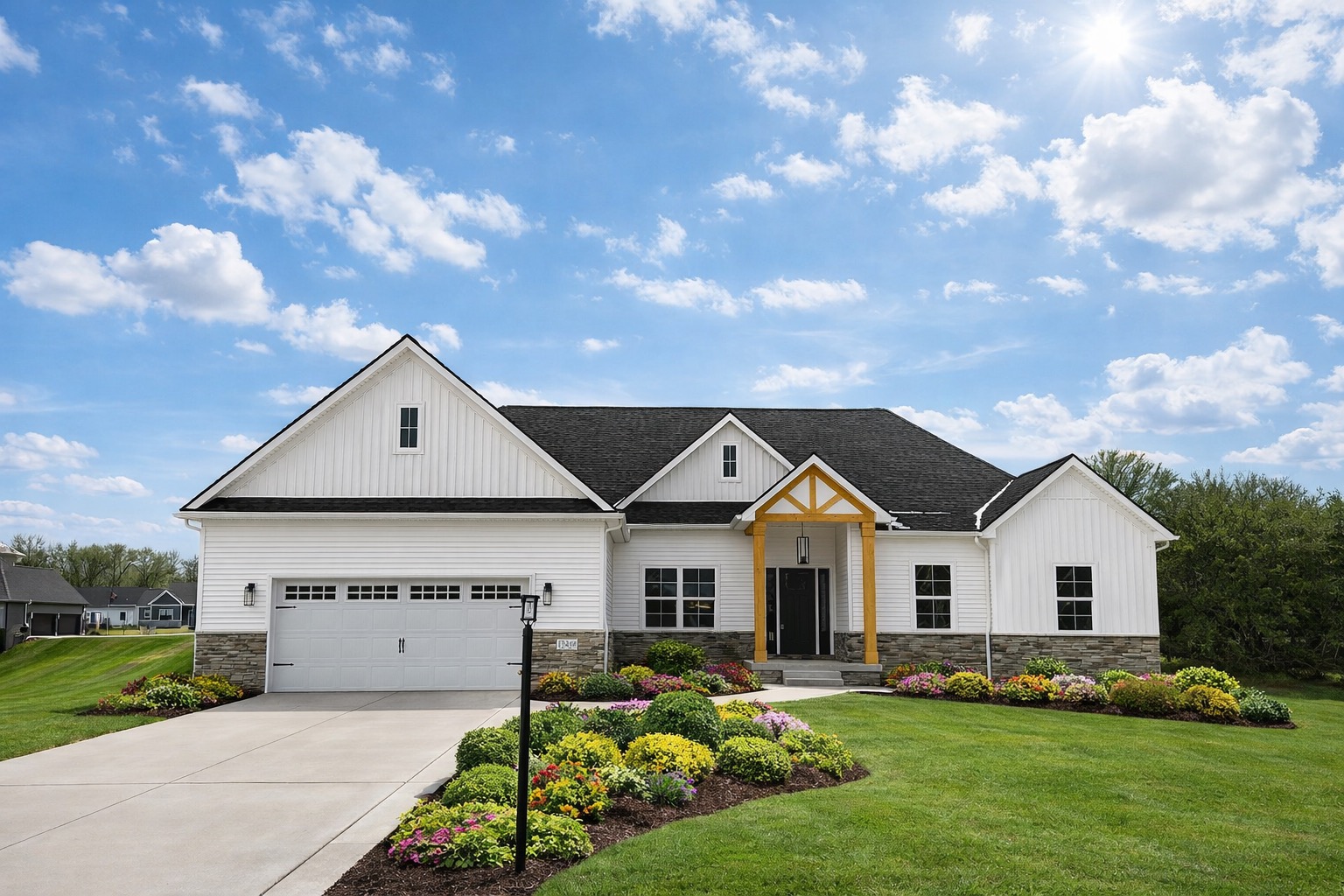 Modern Farmhouse exterior by Big Sky Development featuring white board-and-batten siding, stone veneer accents, wood-accented gabled porch, and professionally landscaped yard