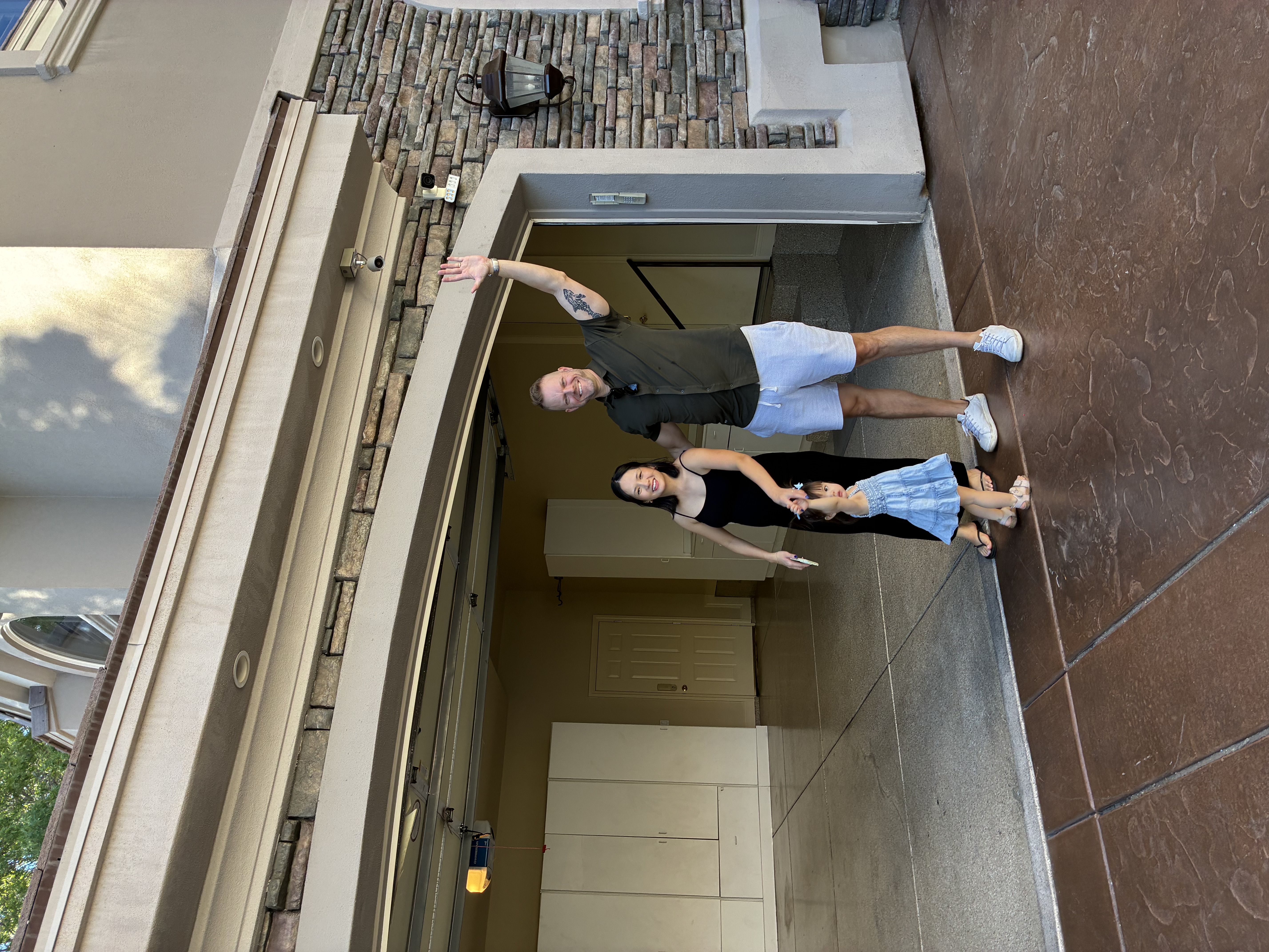 Scott and Mariza in front of their new home