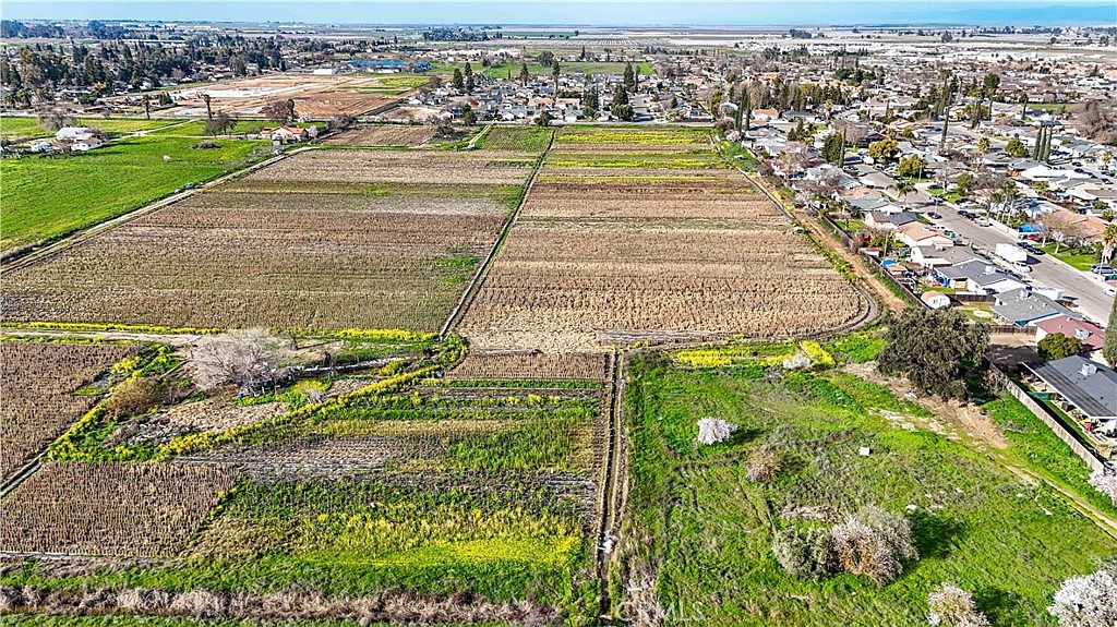 Wide-angle view of the land with irrigation infrastructure visible