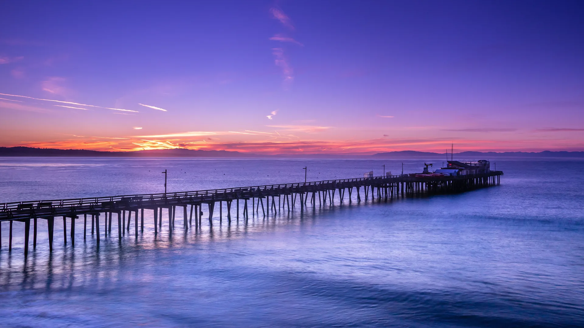 Coastal pier sunset over Monterey Bay in Santa Cruz, California