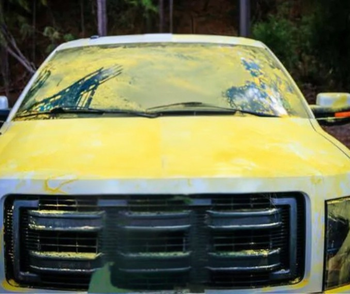 Car covered in yellow pine pollen in Wake Forest NC during spring pollen season
