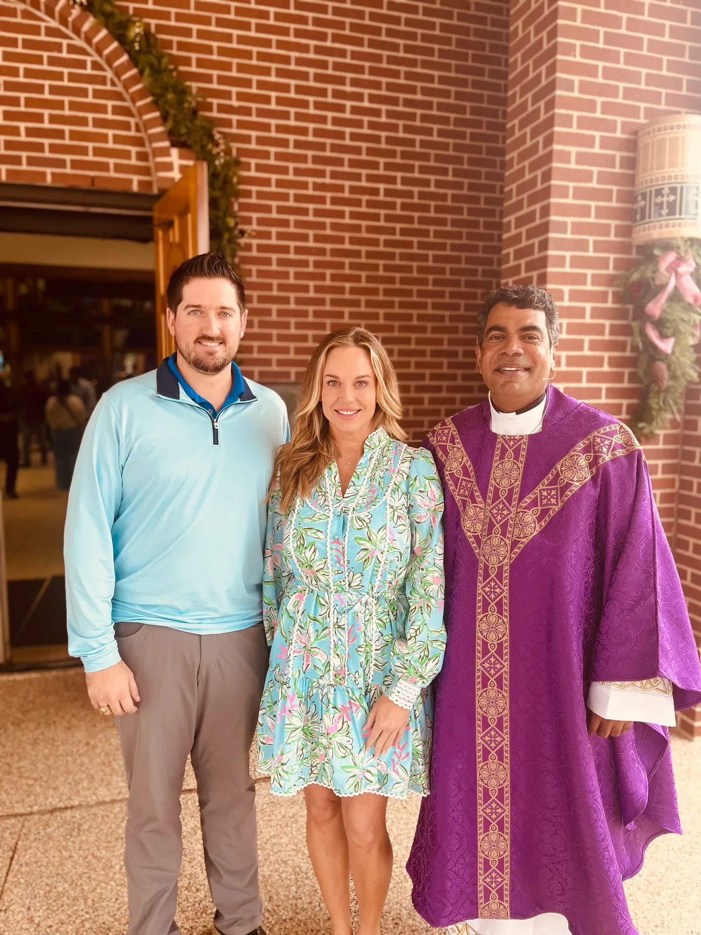 Emily with her priest outside church