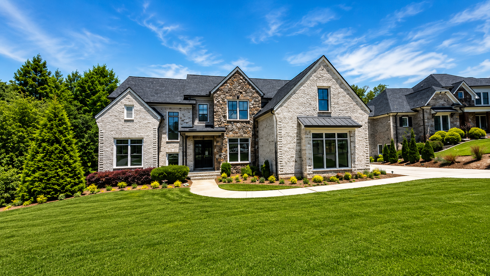 Front exterior of 5760 Lula Bridge Ct, brick two-story estate in the Covered Bridge section of Chateau Elan