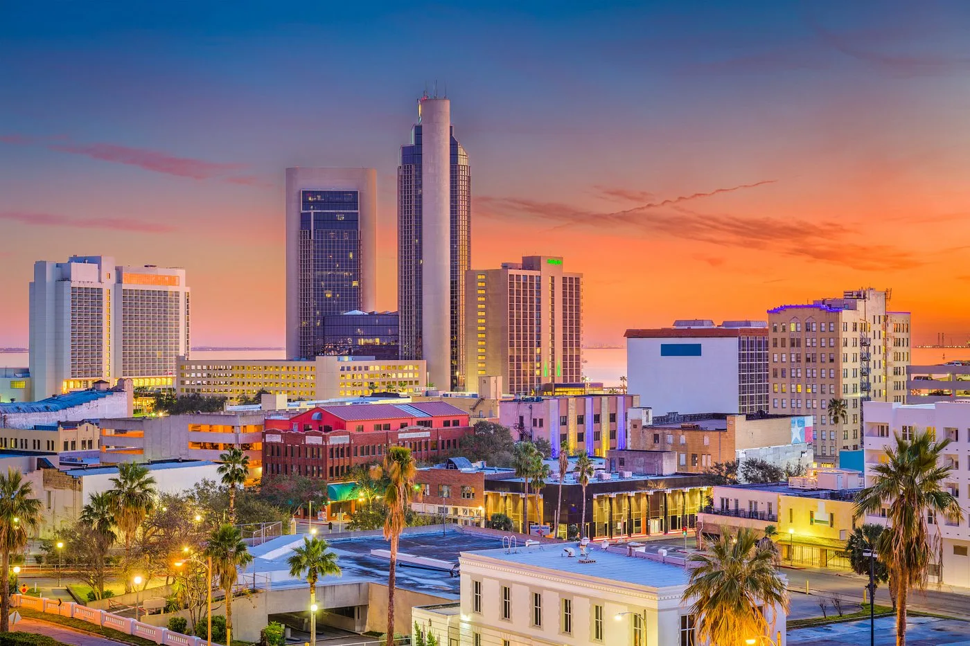 Aerial view of the downtown Corpus Christi skyline at sunset, where the 2027 Coastal Bend housing market outlook is taking shape