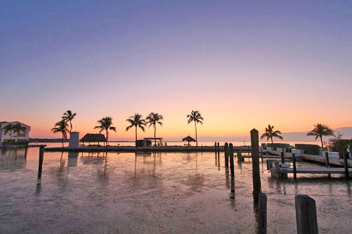 Beautiful sunset over the waterfront in Islamorada, Florida Keys with boats silhouetted against colorful sky