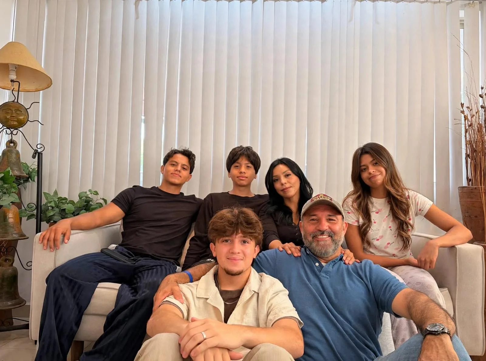 The EndEx Home Group family together, seven people in their living room