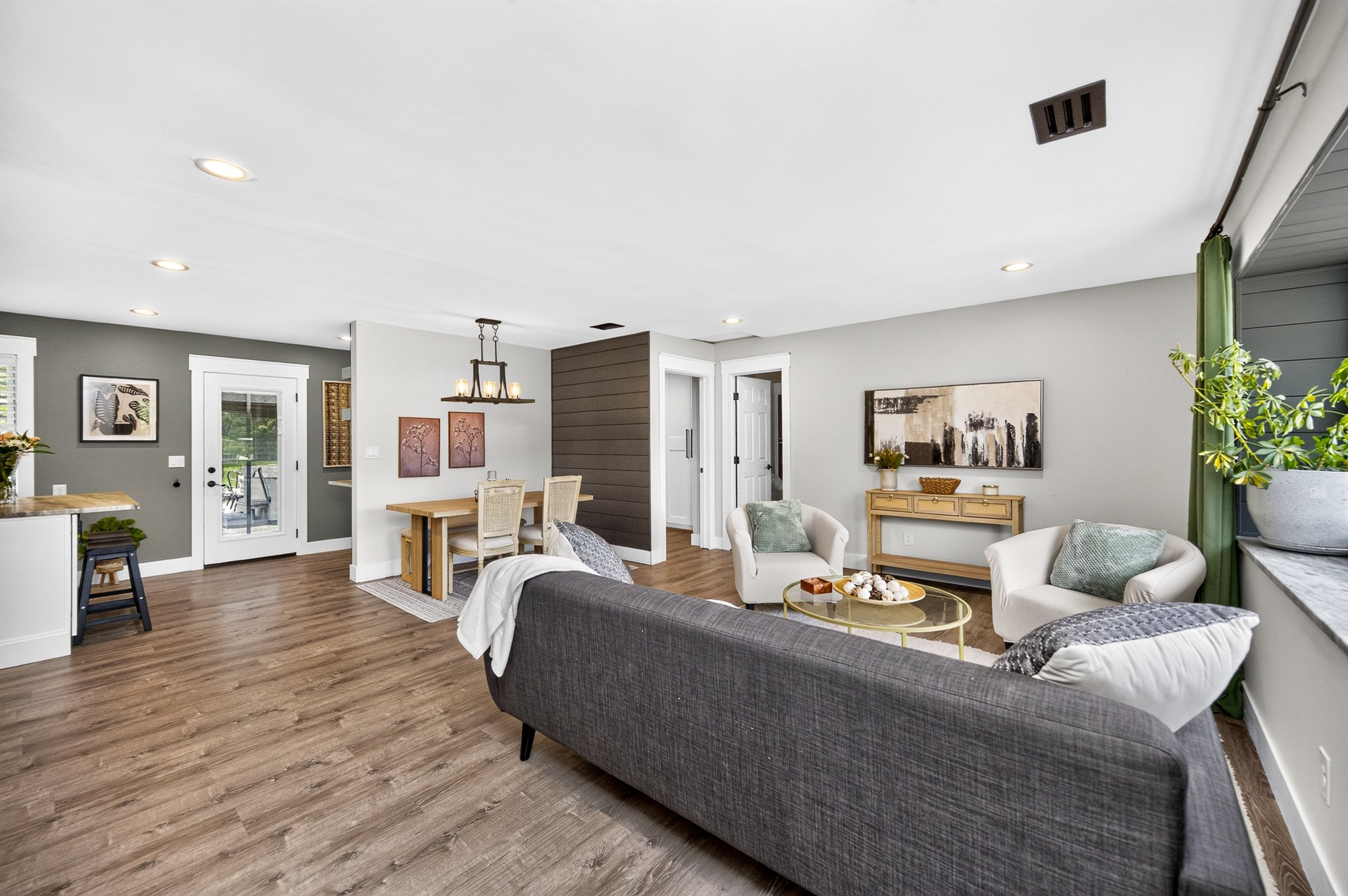 Staged living room with neutral furnishings and layered decor