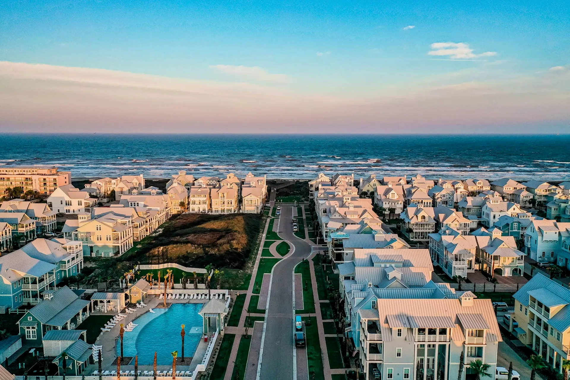 Aerial view of Port Aransas beach houses with a pool right by the ocean