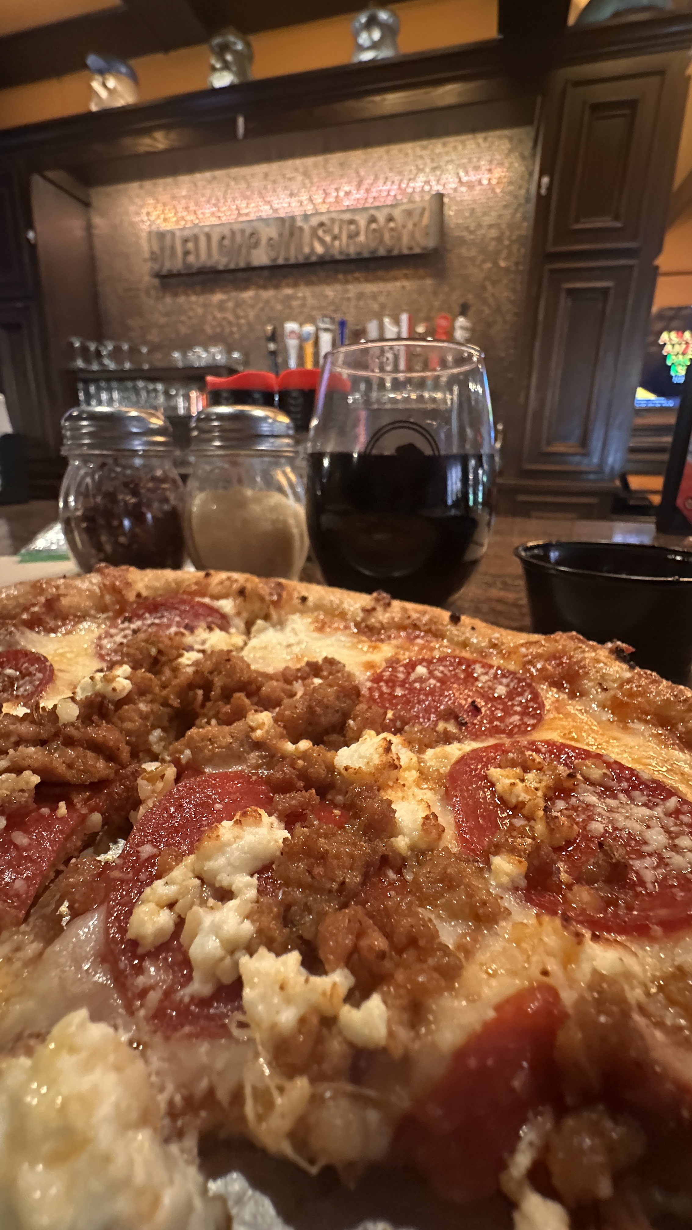 Interior of Mellow Mushroom in Gainesville Georgia with pizza on the table, bar area, and wall sign
