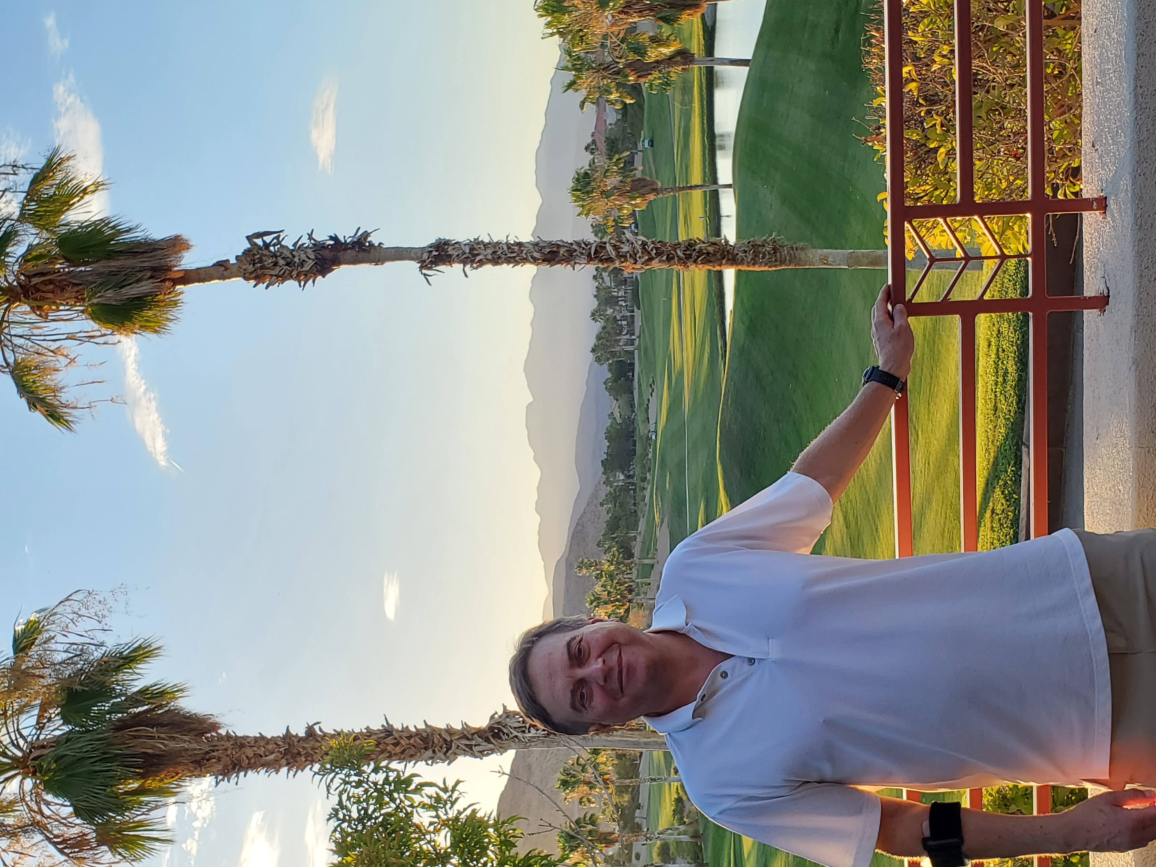 Martin Guaglione at Rhodes Ranch Golf Course, standing on the fairway with the course and desert landscape visible behind him