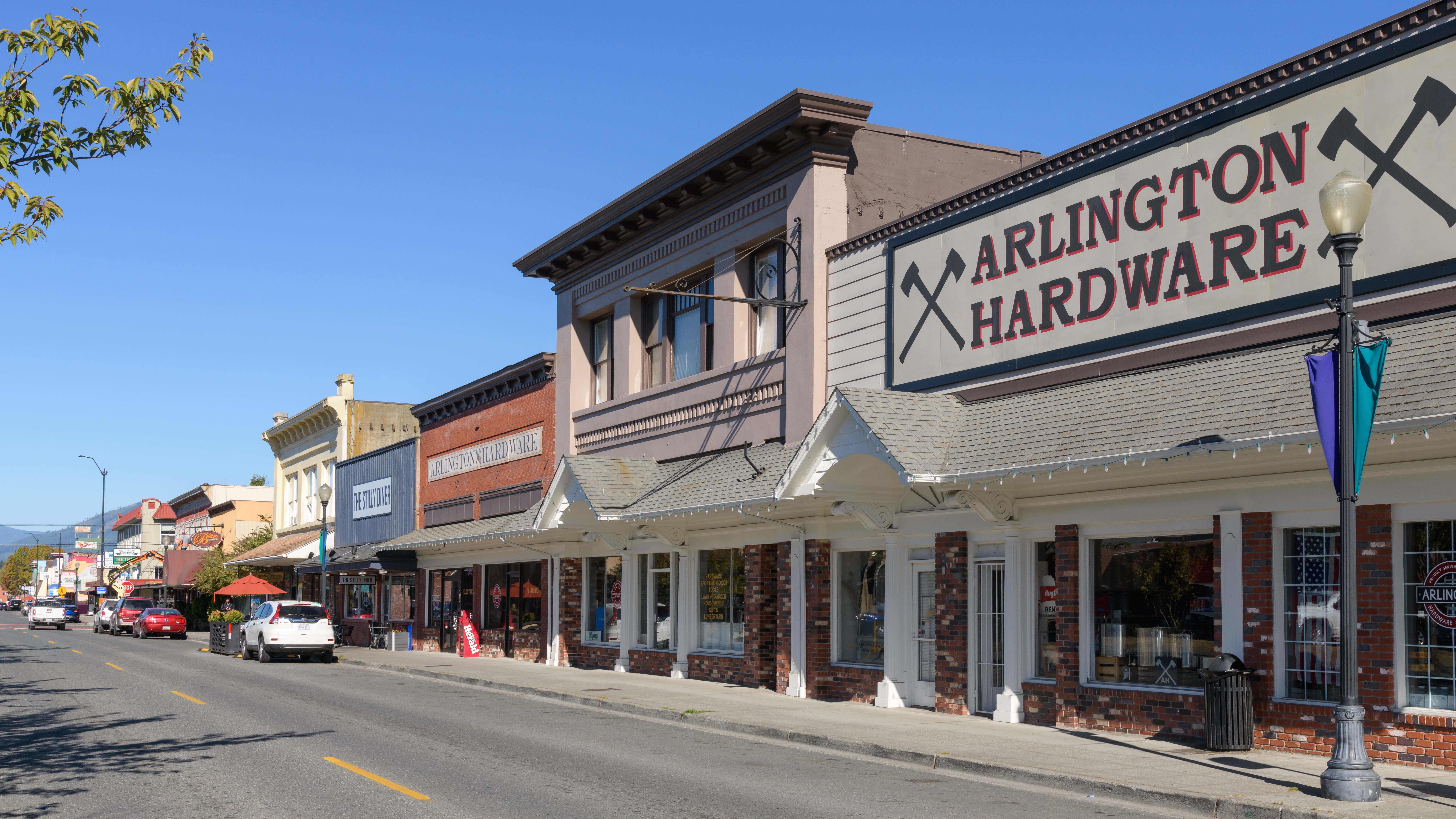 Historic downtown Arlington, Washington, on Olympic Avenue, with the Arlington Hardware storefront among the early-1900s buildings lining the street