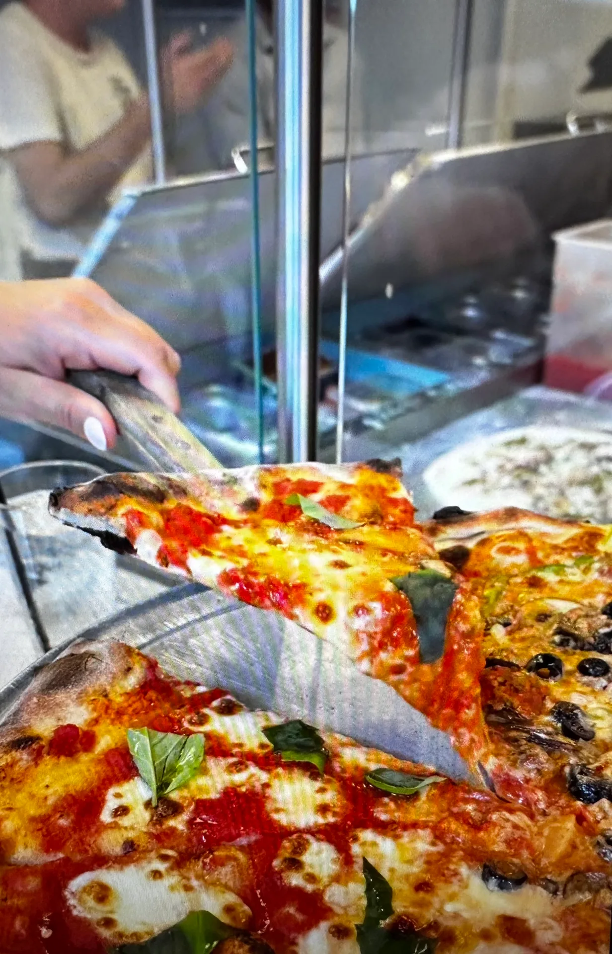 A look at the table at Black Dog Pizza in downtown Columbia, SC, where brick-oven specialty pies share the menu with spritzes and negronis