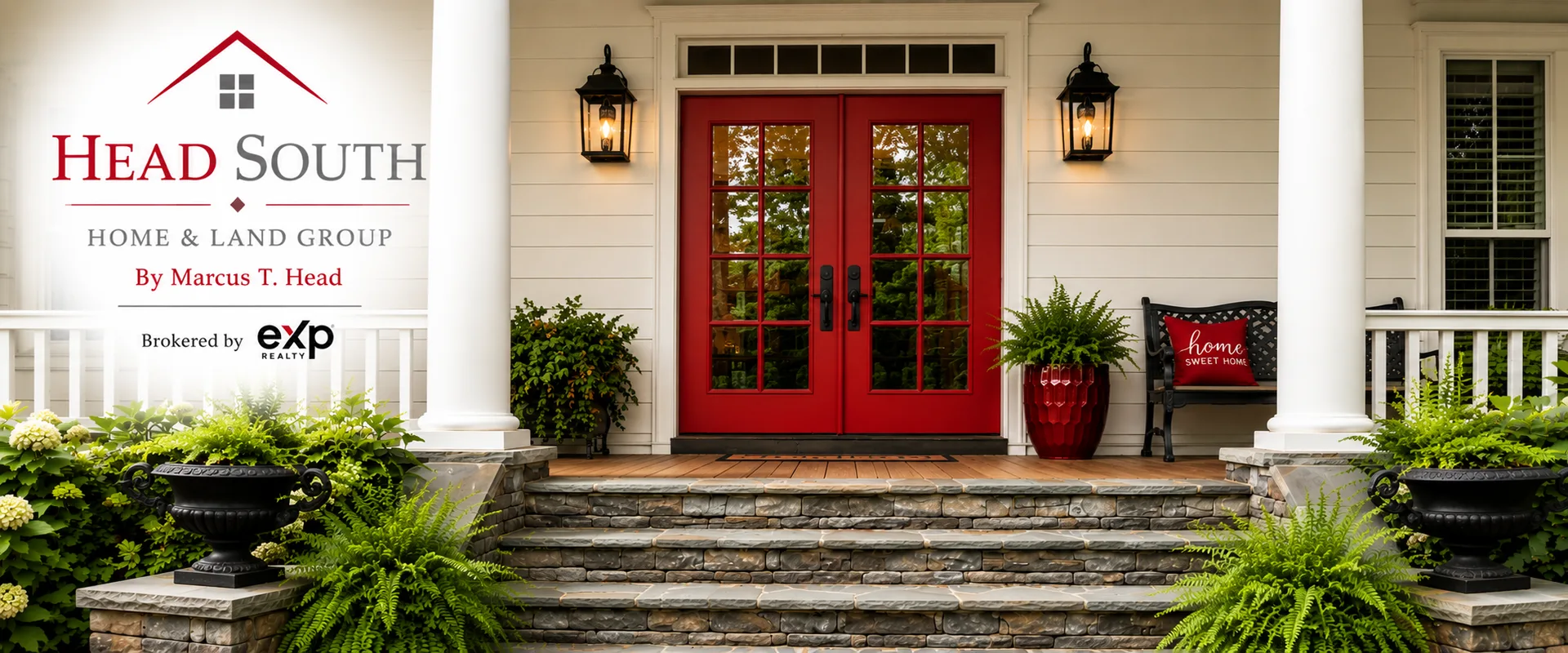 Beautiful property entrance with stone steps, white columns, and a red front door