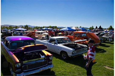 Summer Salute charity car show in Northern Nevada featuring classic cars on a grassy field with pop-up canopies and mountains in the background