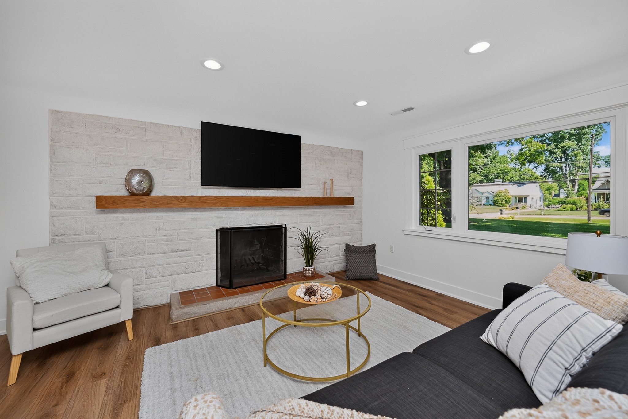Staged bedroom with crisp white bedding and coastal decor accents