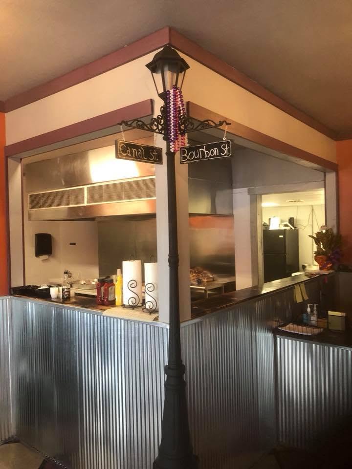 Smoked ribs, a pulled pork sandwich,and loaded brisket fries served on butcher paper in a warm, wood-paneled smokehouse dining room