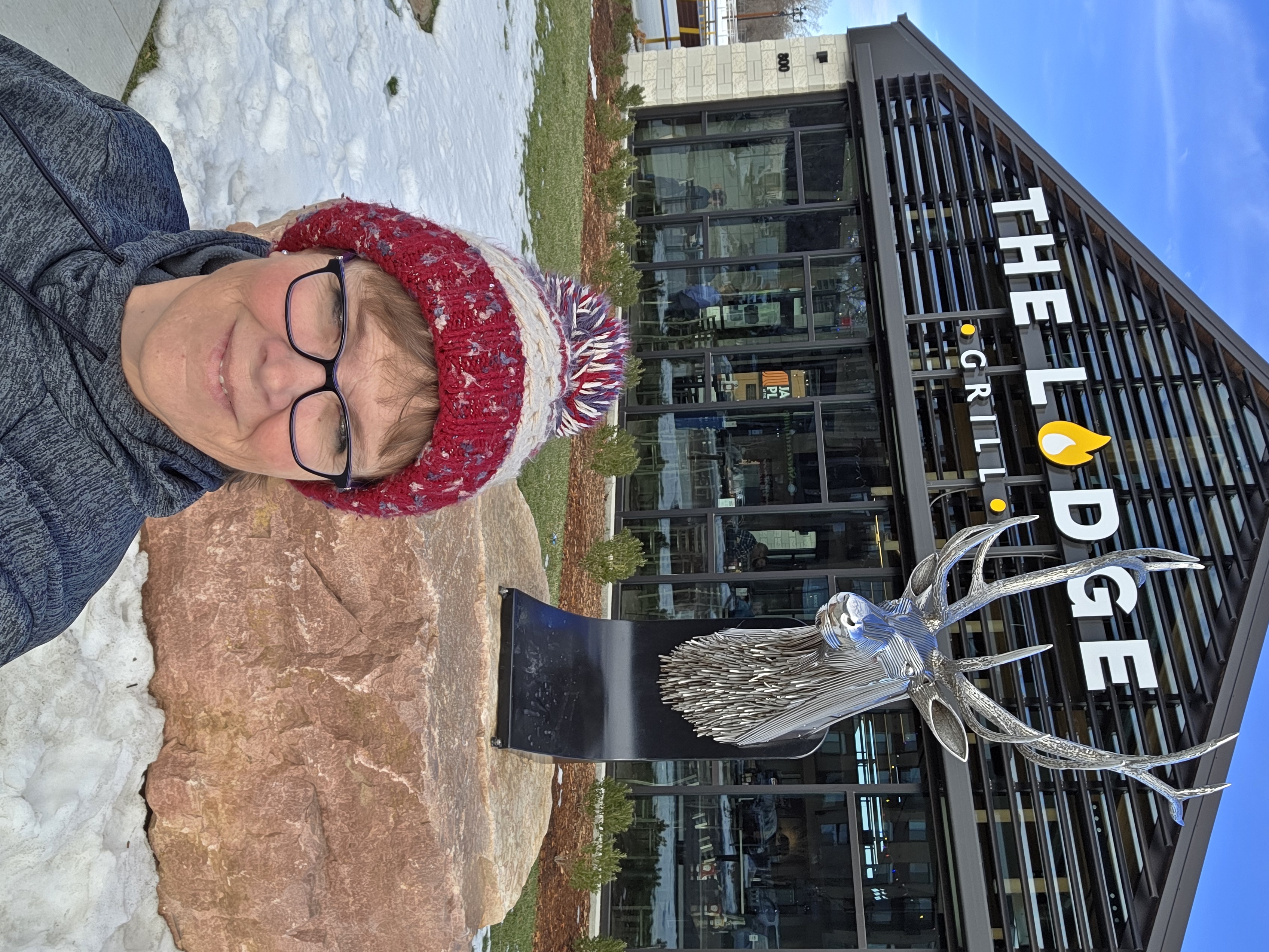 Selfie of Jennifer Krosch with the Elk sculpture outside the Lodge Grill at Jacobson's Plaza in downtown Sioux Falls