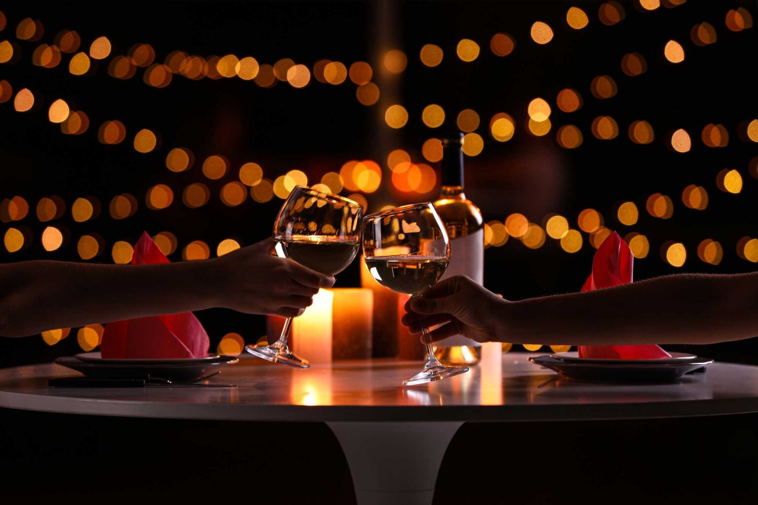 A candlelight dinner for two in Lake County, glasses raised under warm string lights