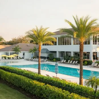 Clubhouse and community center entrance with columns and tropical landscaping in the Gateway community of Fort Myers