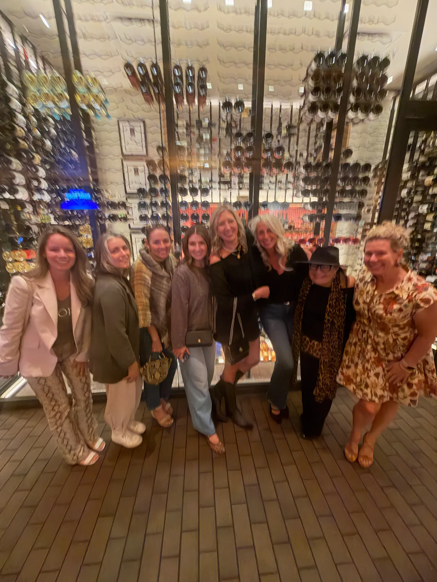 A group of eight agents posing together at a team social event