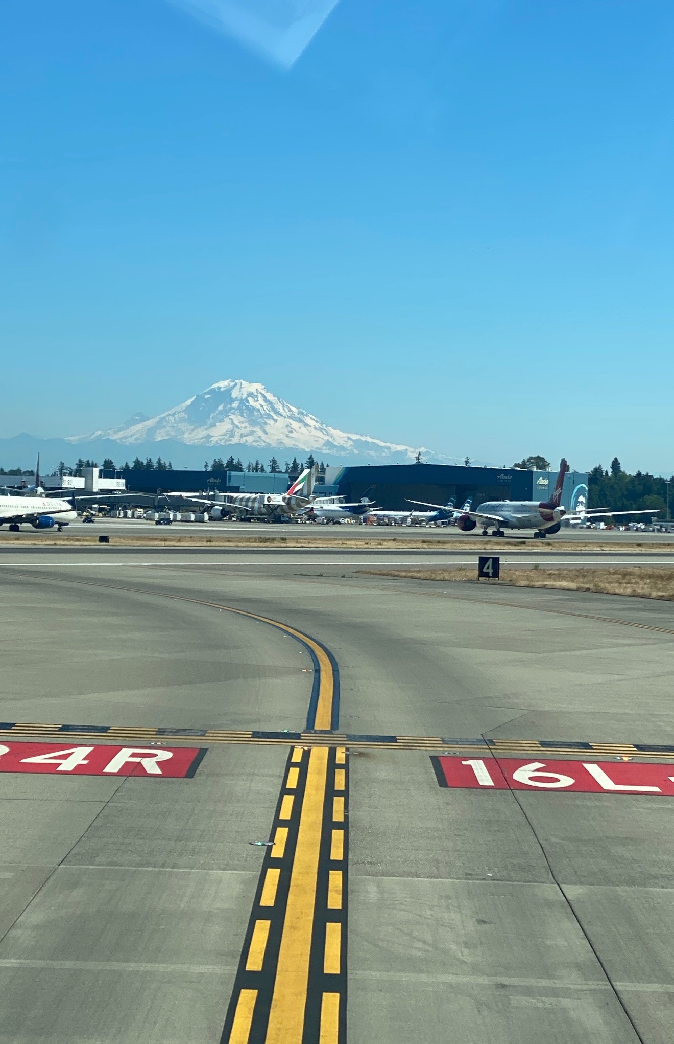 SEA tarmac with Mount Rainier rising above the airport, showing the landscape pilots see when building a life at base