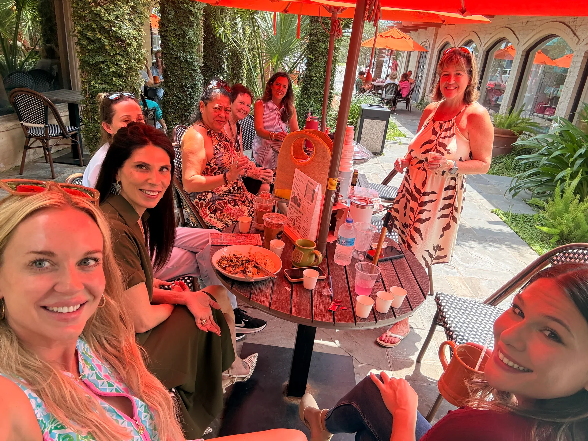 Seven women enjoying a patio lunch together at a Dream Life Wellness gathering