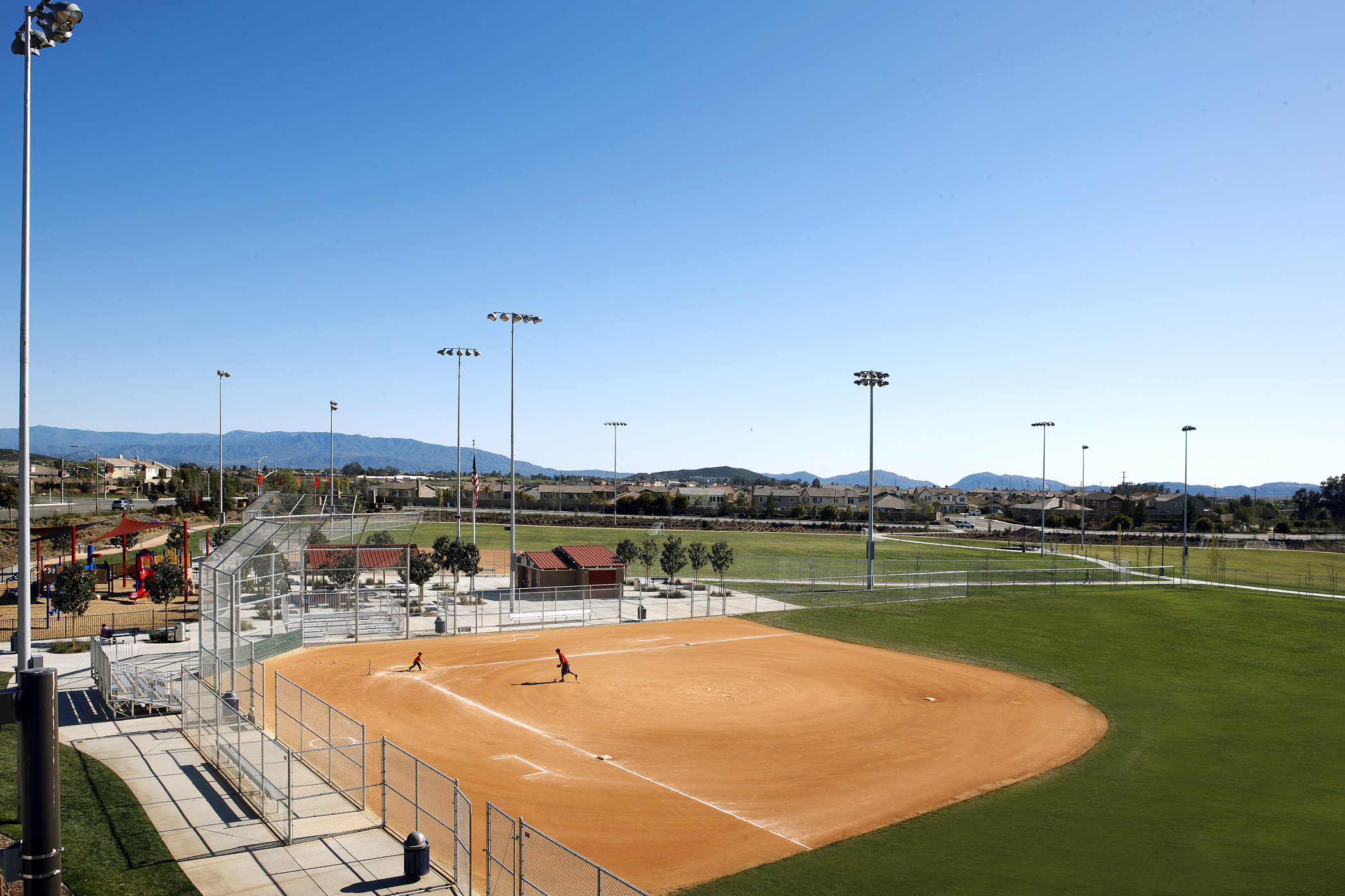 Residential landscape view of Spencer's Crossing community in Murrieta California featuring homes, trees, and open sky