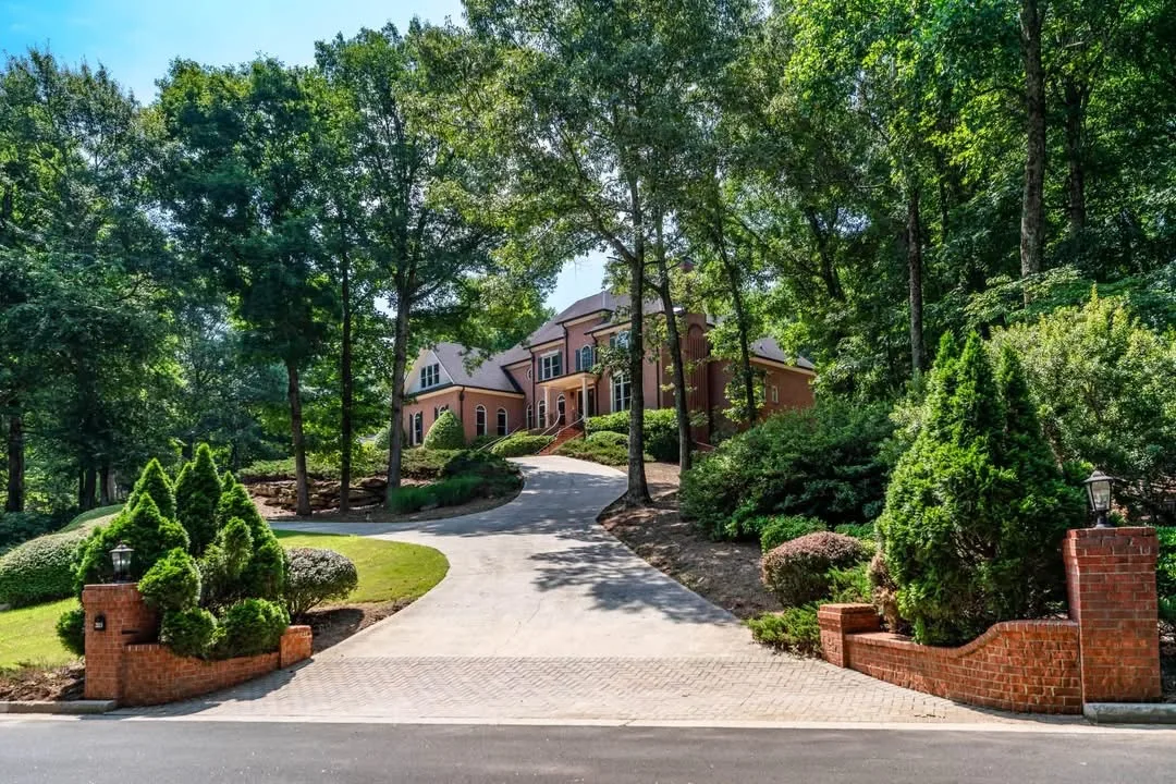 Exterior perspective of 2115 Tee Drive along the Woodlands Course